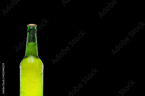 Green beer bottle isolated on black background. Place for text. Copy