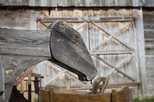 Wooden figure of a cow on a farm.