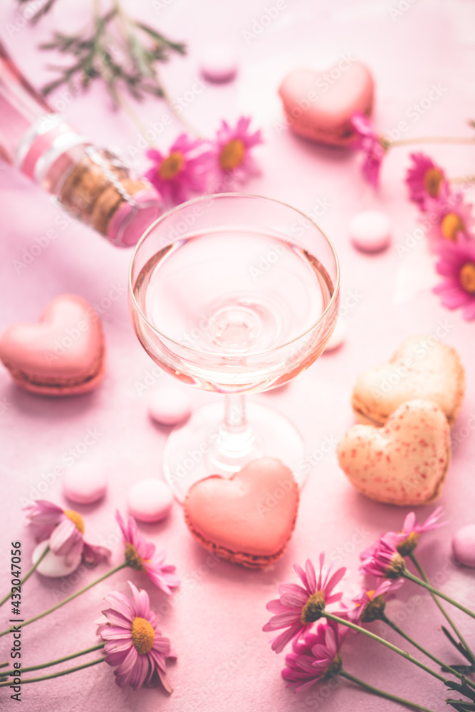 Happy Mothers Day - sweet macarons in heart shape and glass of rose sparkling wine Happy Mothers Day - sweet macarons in heart shape and glass of rose sparkling wine