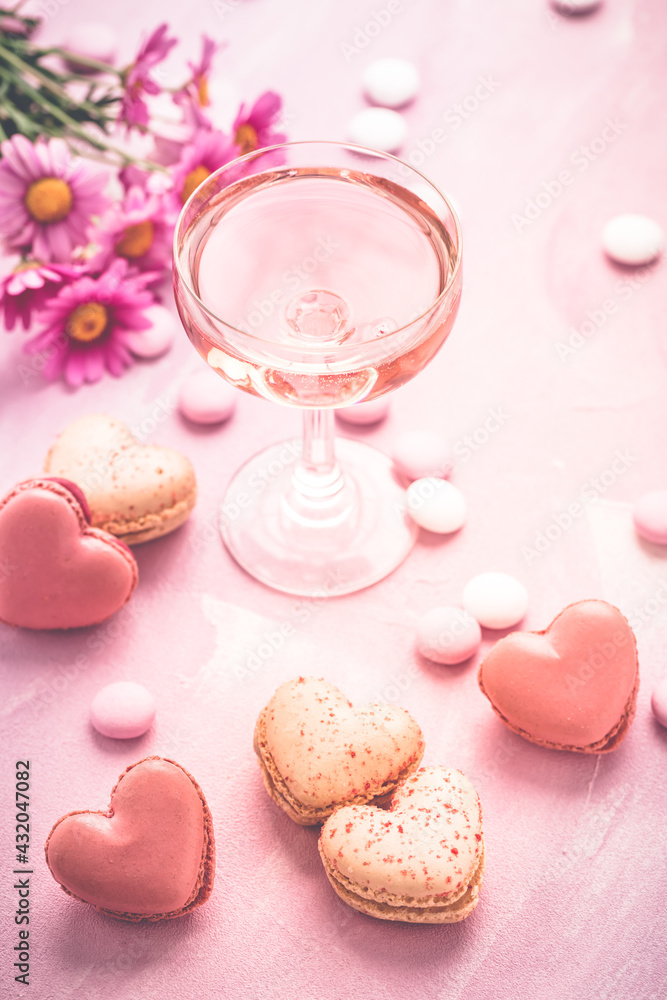 Happy Mothers Day - sweet macarons in heart shape and glass of rose sparkling wine Happy Mothers Day - sweet macarons in heart shape and glass of rose sparkling wine