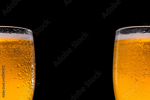 Two beer Glasses beer on black background. Space for text and logo