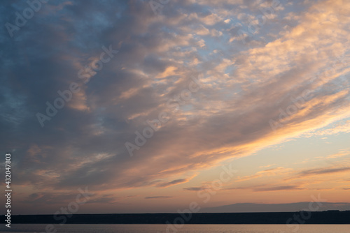 Beautiful sky at sunset and a thin line of the horizon. Creative vintage background.