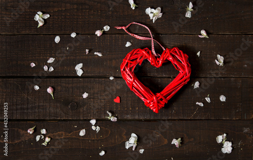 Shape of red heart as symbol of love on rustic wooden background. Greeting card for Valentine's Day, Women's Day and Mother's Day. Top view. Flat lay