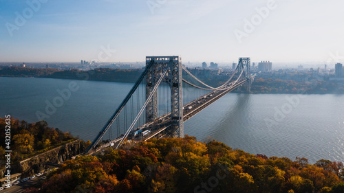 Aerial of George Washington Suspension Bridge over Hudson River at Autumn Sunrise - Interstate 95, US Route 1 & 9 - Fort Lee, New Jersey & Bronx, New York City, New York