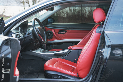 Luxury car interior with red leather seats and black details © Aleksander