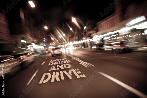 City Road at night, blurry vision with message don't drink and drive. a glimpse of how an intoxicated person may view the road when in the front seat of a car
