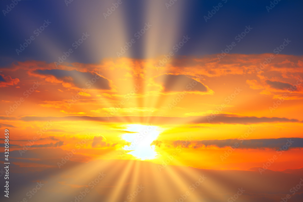 Fototapeta premium Spectacular orange sky with sun rays in the evening . Sunset with dark blue clouds