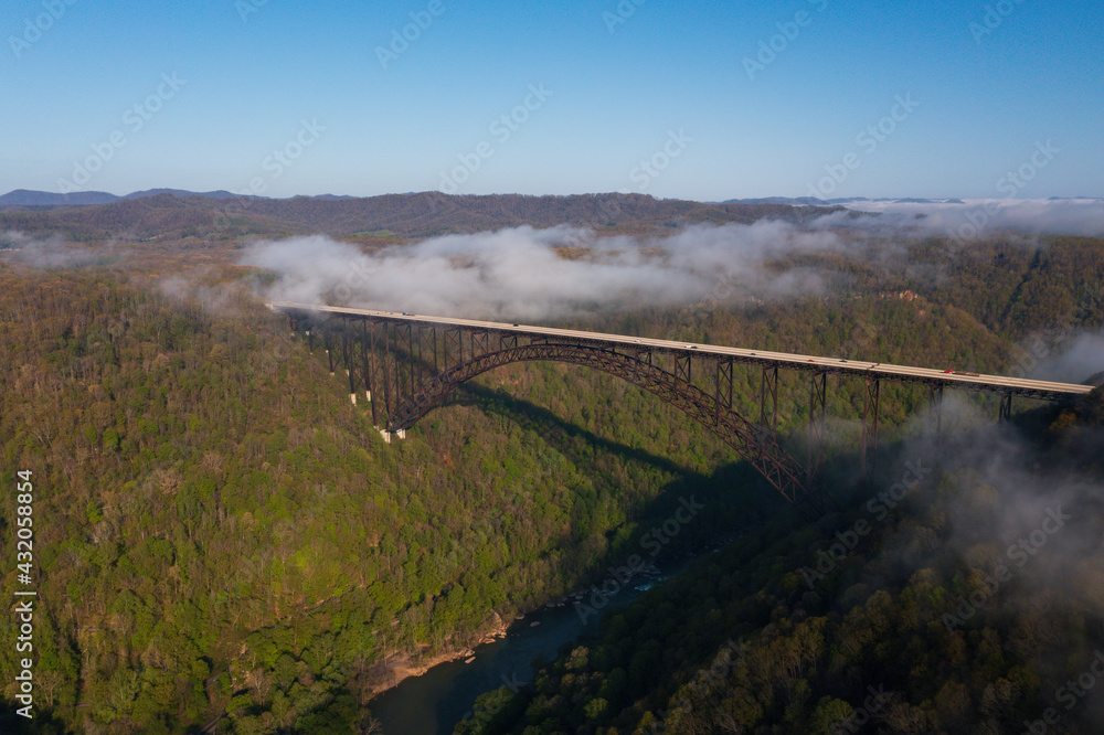 Fototapeta premium Aerial of New River Gorge Bridge on Foggy Spring Morning - US Route 19 / Corridor L - New River Gorge National Park & Preserve - West Virginia