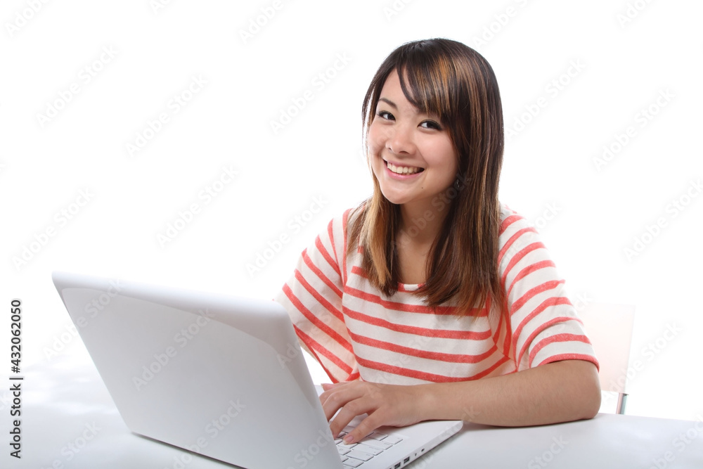Young Japanese female student operating a personal computer Young Japanese female student operating a personal computer