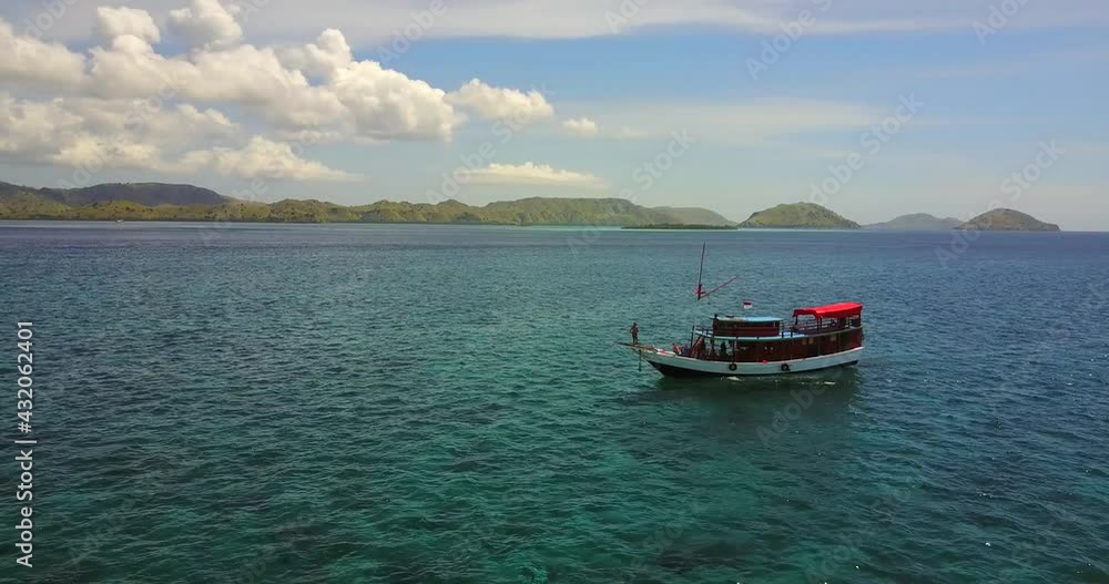 Aerial view around boats in tranquil water, on the coast of, Indonesia - circling, drone shot Aerial view around boats in tranquil water, on the coast of, Indonesia - circling, drone shot