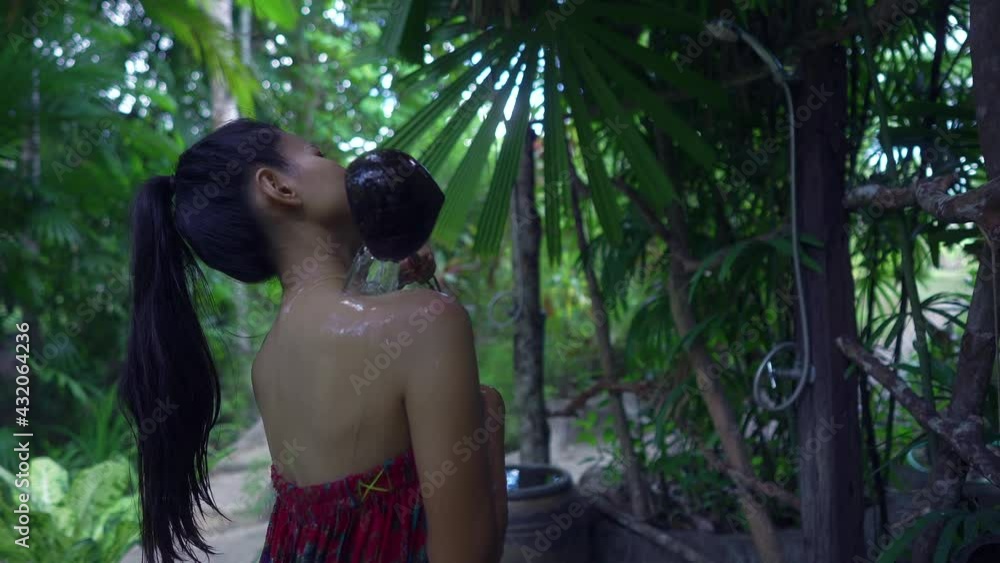 Cute Asian Girl pouring water in a Hot Spring in Slow Motion, Thailand. Cute Asian Girl pouring water in a Hot Spring in Slow Motion, Thailand.