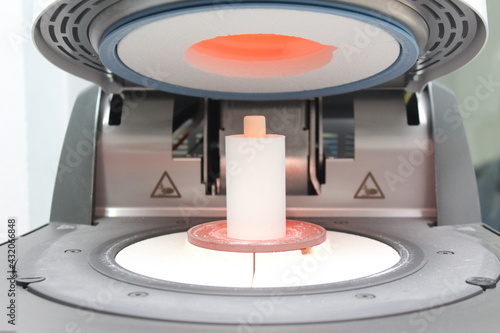 Pressing the new teeth with ingot material in the oven