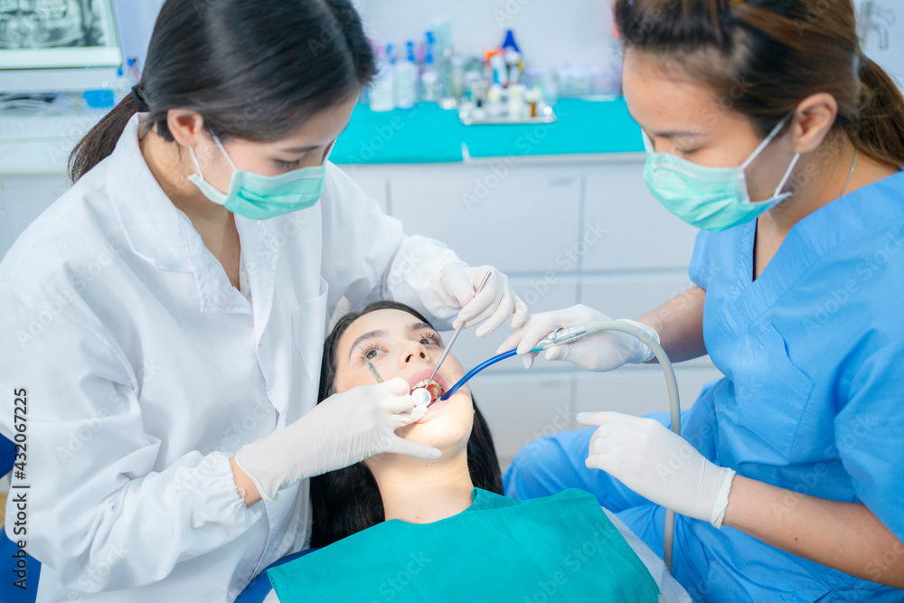 Asian dental team providing oral treatment service in dental clinic. Asian dental team providing oral treatment service in dental clinic.