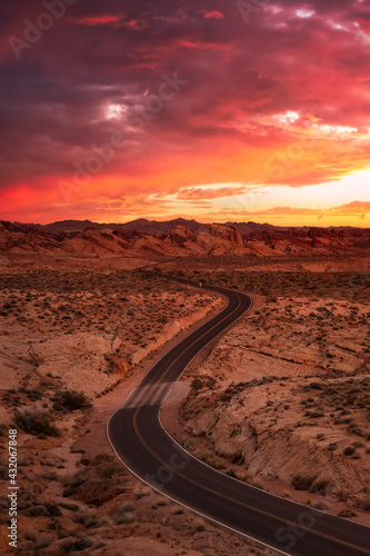 Valley of Fire State Park, Nevada, United States. Scenic road in the desert during a cloudy twilight. Dramatic Sunrise Sky Art Render.