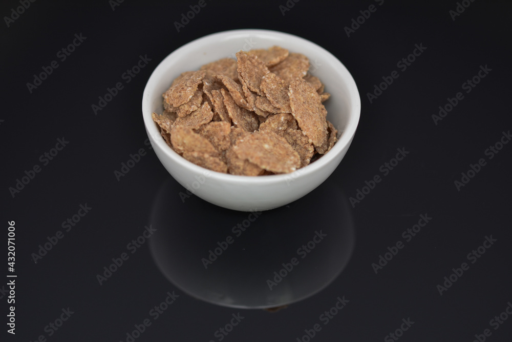 Breakfast Cereal , cocoa cornflakes in a white bowl Breakfast Cereal , cocoa cornflakes in a white bowl