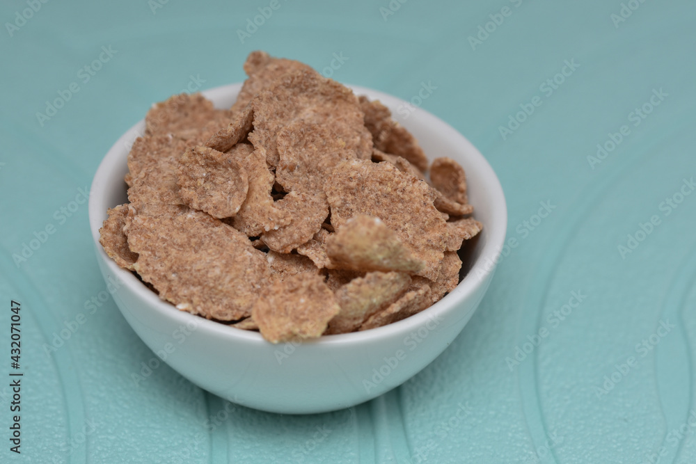 Breakfast Cereal , cocoa cornflakes in a white bowl Breakfast Cereal , cocoa cornflakes in a white bowl