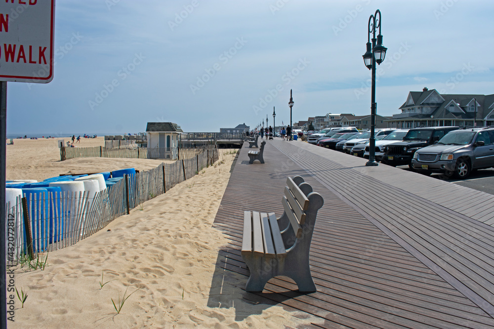 Relatively empty beach boardwalk on a warm spring day in Belmar, New Jersey -01