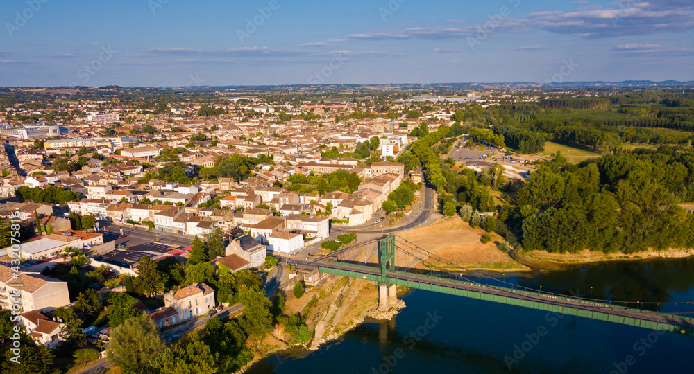 Panoramic aerial view of Marmande city on Garonne river on sunny summer day, Gironde, France