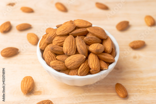 A bowl of roasted almonds, Nuts are low in carbs but high in healthy fats, protein, and fiber. close-up shot.