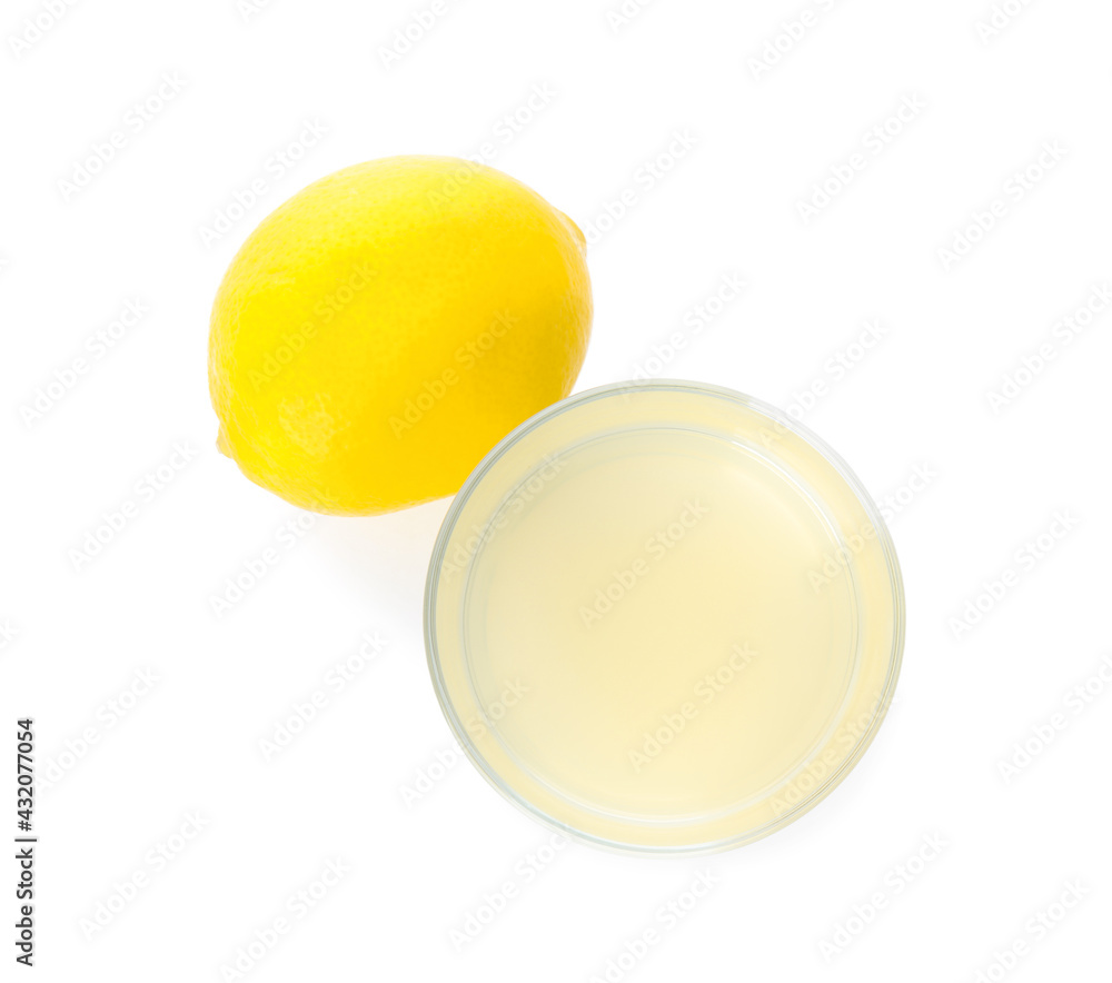 Freshly squeezed lemon juice on white background, top view