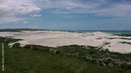 Crane up over Contrasting green landscape with sandy Beach, South Africa