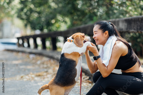 Woman and dog running and exercising outdoor in the park