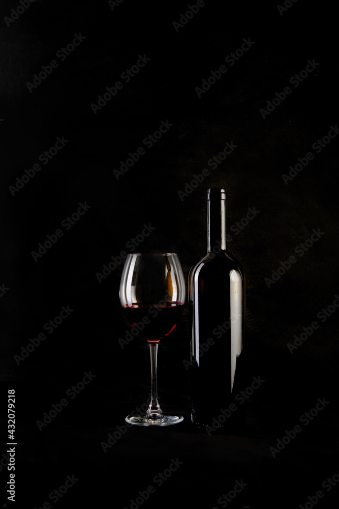 Red wine bottle with 2 glasses and bottle opener on black background. - obrazy, fototapety, plakaty 
