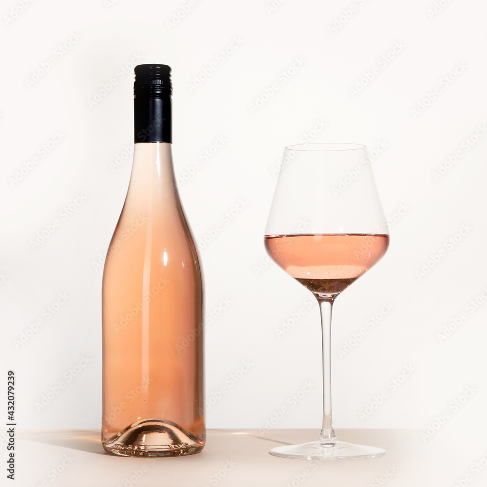 Young woman holding glass of rose wine on white background. Hand with black polish. Young woman holding glass of rose wine on white background. Hand with black polish.