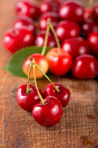 Cherries on wooden table with water drops