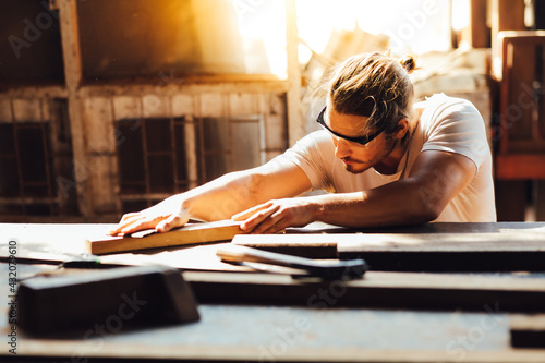 Carpenter woking at wood workshop. Construction industry concept. Tools for woodwrok pencil hammer meter and screw-driver. photo