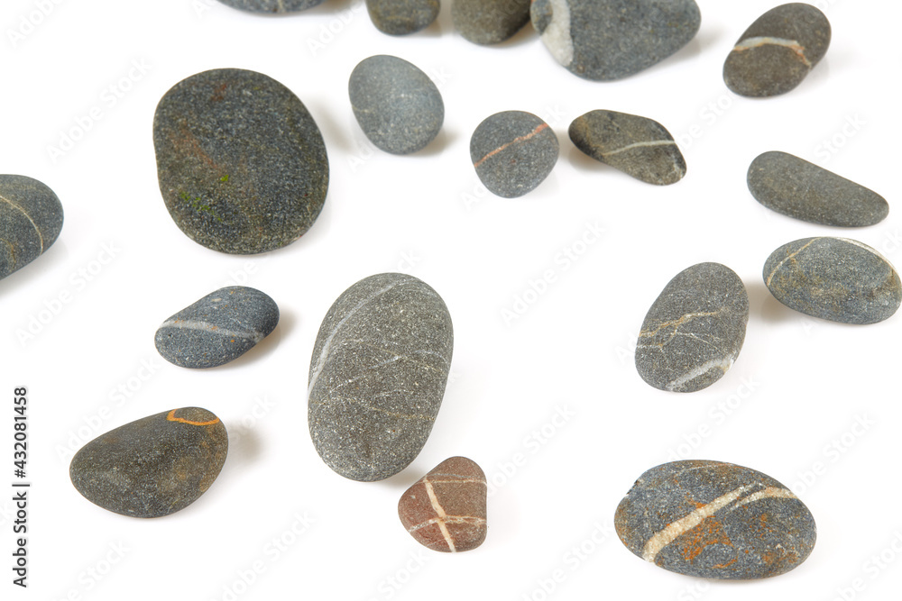 Grey pebbles isolated on white background. Grey sea stones with white stripes isolated on white. Studio shot. Grey pebbles isolated on white background. Grey sea stones with white stripes isolated on white. Studio shot.
