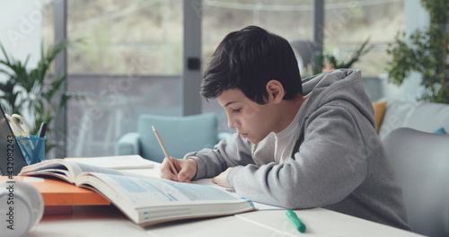 Student sitting at desk and doing homework