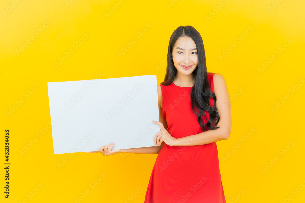 Portrait beautiful young asian woman smile with empty white billboard Portrait beautiful young asian woman smile with empty white billboard