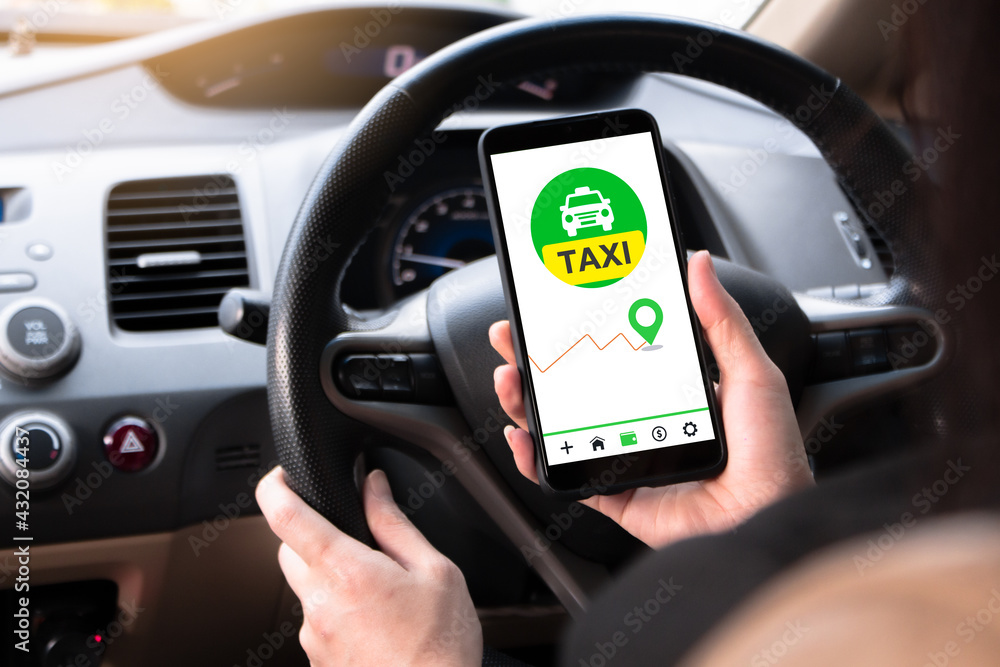 Women are using a smartphone application taxi to serve customers. Provide directions to customers. Use hands to steer the car to travel to the destination. Women are using a smartphone application taxi to serve customers. Provide directions to customers. Use hands to steer the car to travel to the destination.