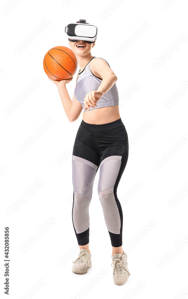 Sporty young woman with virtual reality glasses playing basketball on white background