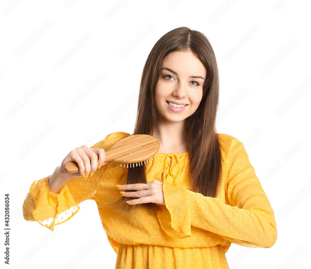 Beautiful young woman with hair brush on white background Beautiful young woman with hair brush on white background