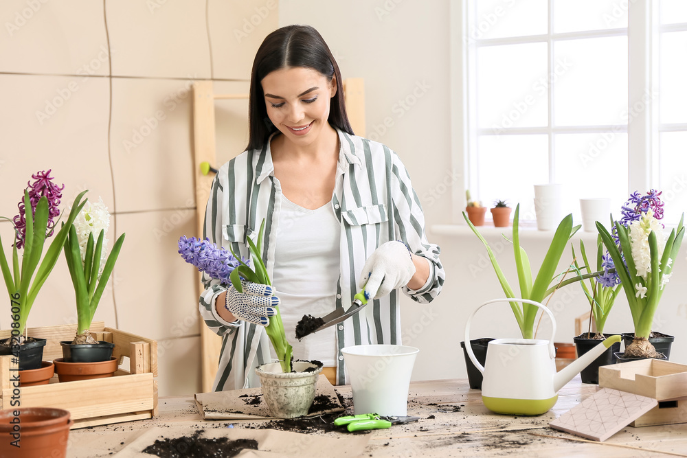 Female gardener taking care of plants at home Female gardener taking care of plants at home