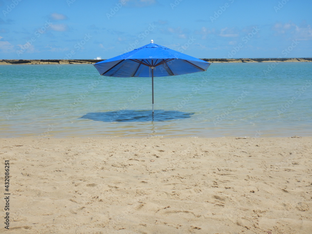 blue sombrero on sunny deserted beach