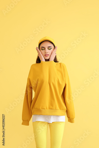 Stylish young woman on yell...