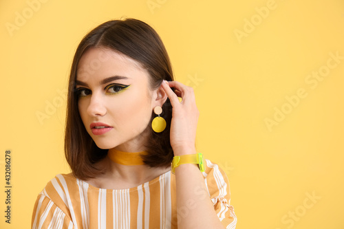 Stylish young woman on yell...
