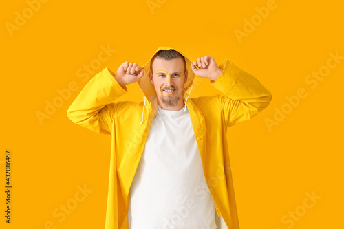 Stylish young man on yellow...