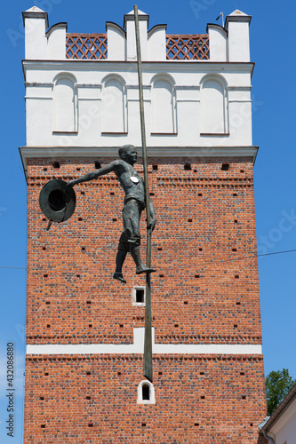 Canvas Print 14th century gothic entrance Opatowska Gate, sculpture of a bargeman going down