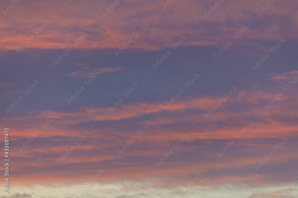 Stunning pink pastel sunset sunrise over the Canadian wilderness. Purple colors seen in the bright, cloudy sky. 