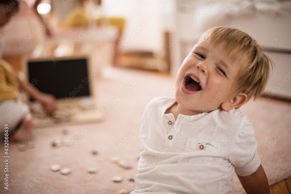 Little boy sitting in room and looking at camera. Little boy sitting in room and looking at camera.