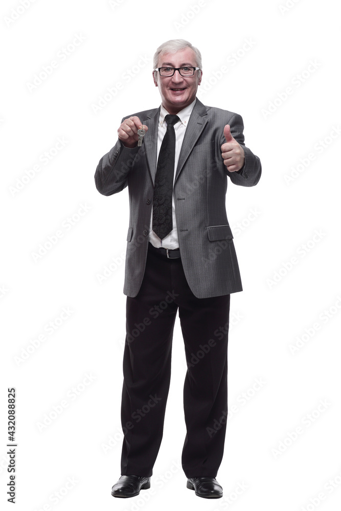 in full growth. business man with keys in hand. in full growth. business man with keys in hand.