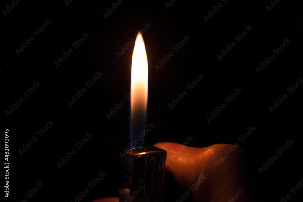 fire lighter with hand on a black background fire lighter with hand on a black background