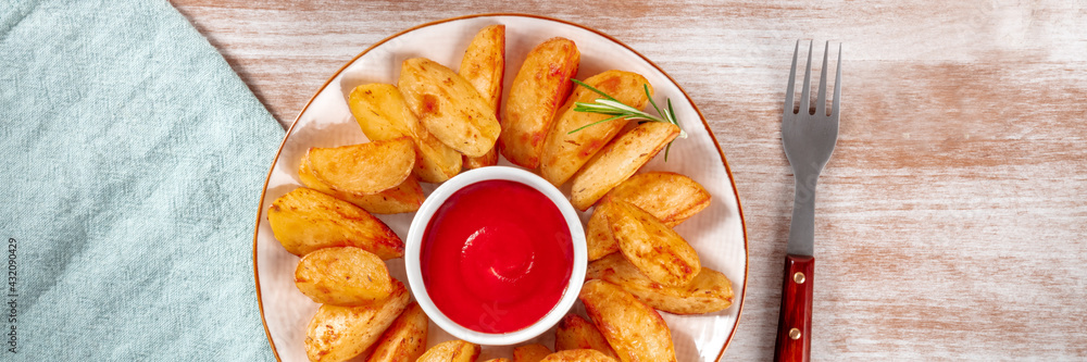 Baked potato wedges panorama with a fork and a napkin Baked potato wedges panorama with a fork and a napkin