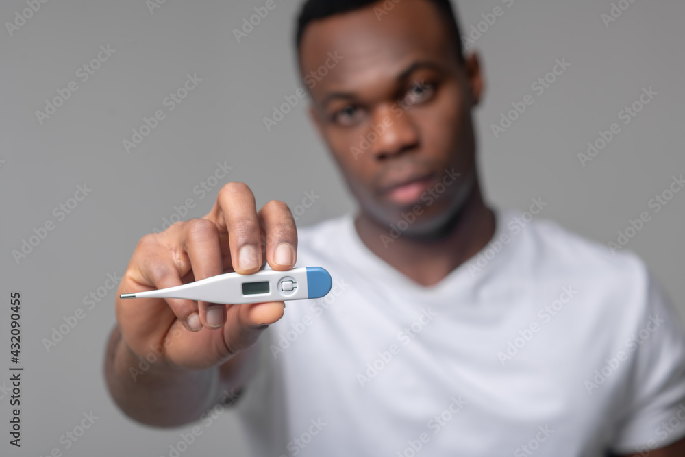 Photography Man holding out thermometer to camera