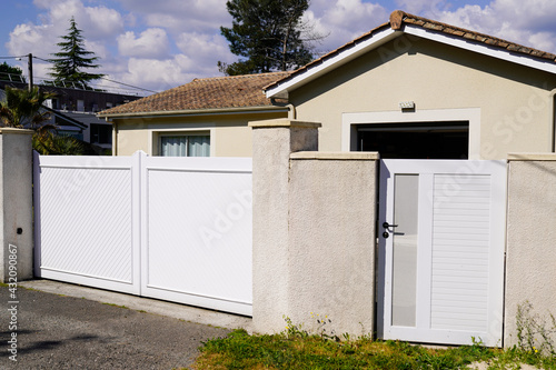 portal aluminum white design metal gate of suburb house and steel door access home garden © OceanProd