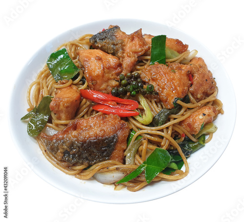 Thai Drunken spaghetti with fried salmon, modern Thai fusion food from stir fried spicy noodles menu (pad kee mao, pad ki mao) with Thai herbs include green peppercorn, Kaffir lime leaves and chili.